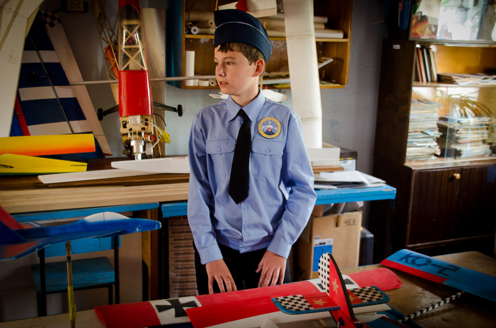 International Air Cadet standing in front of model aircraft
